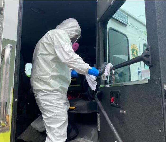 Worker cleaning the inside of a truck