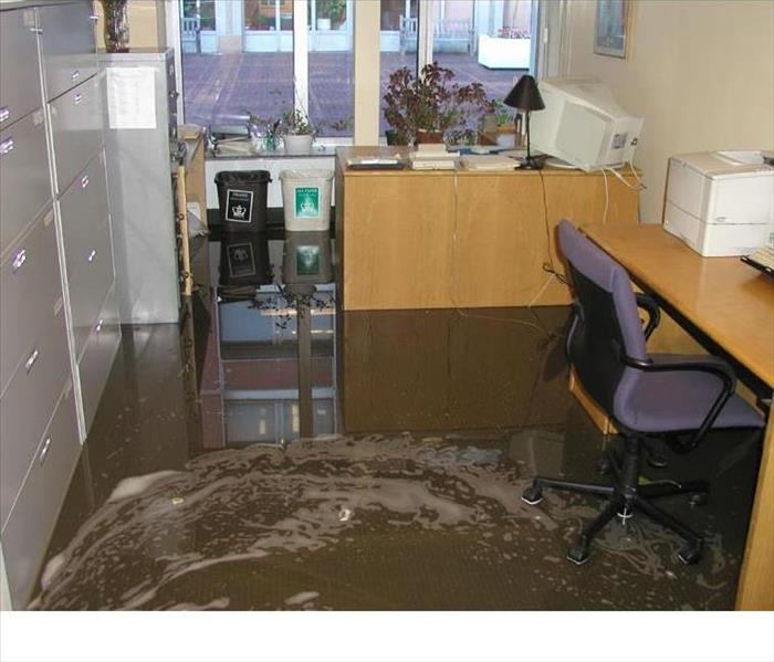 Swirling water on the floor of a carpeted office
